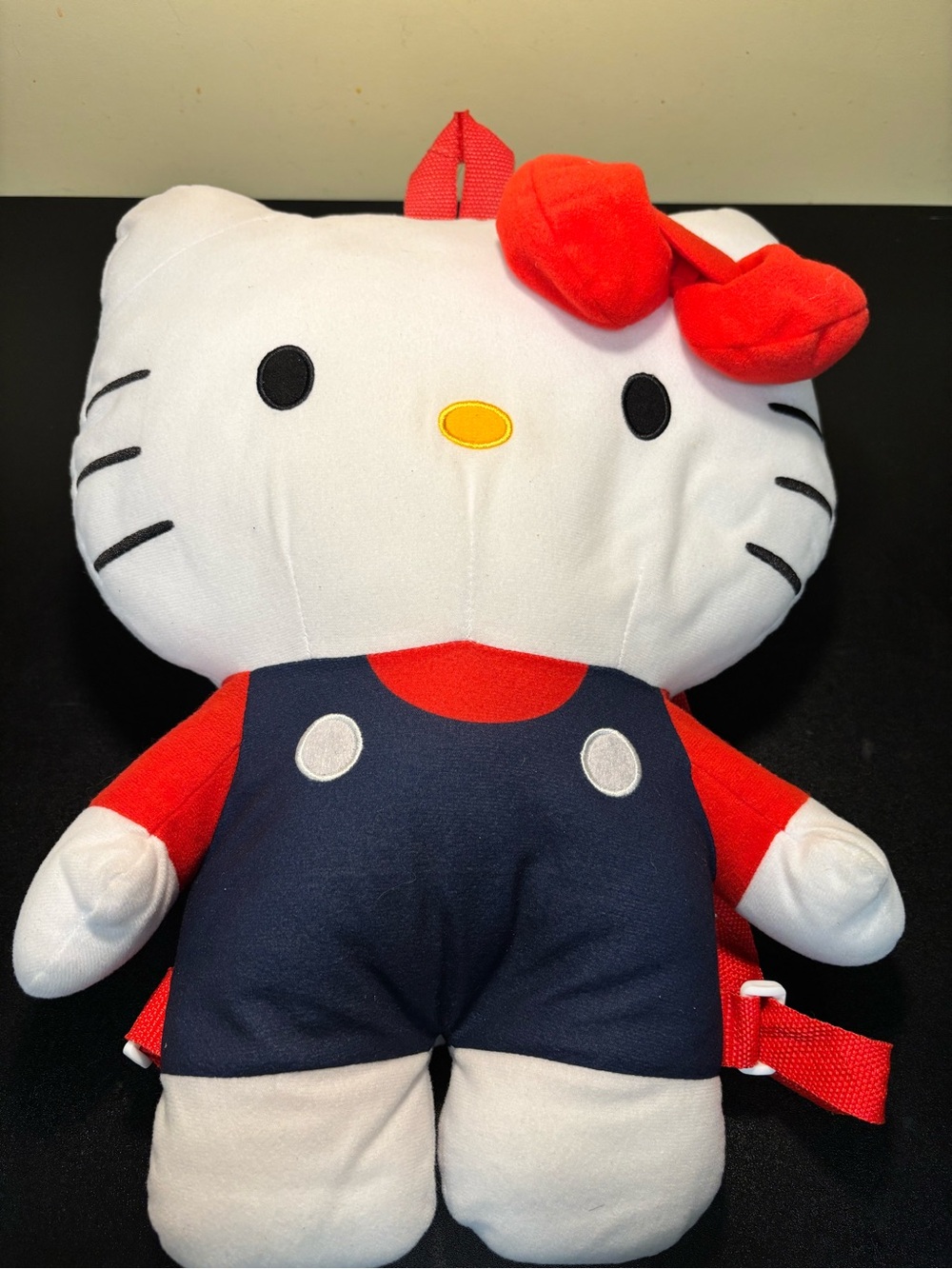 Hello Kitty plush backpack featuring a soft white design and classic blue overal